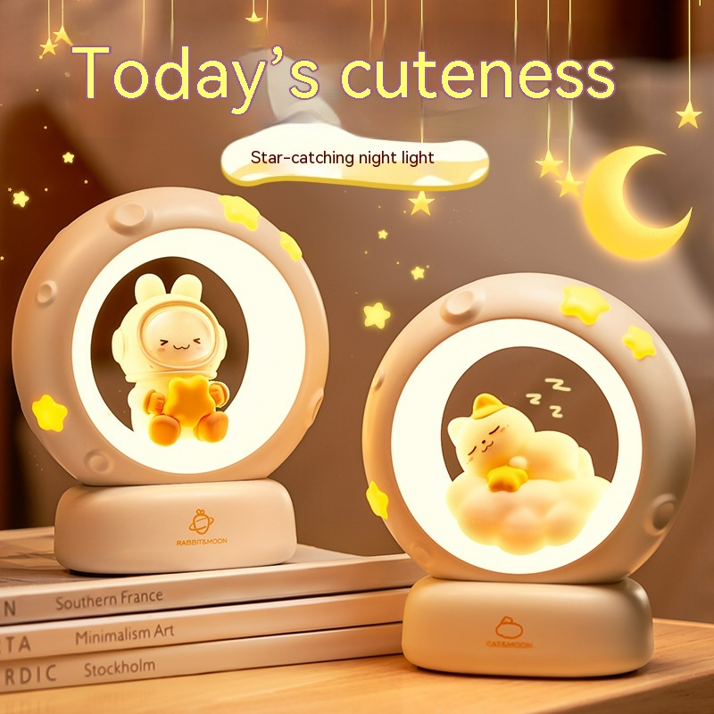 Two moon night light lamps with cartoon bunny and cat figures, glowing rings on bases