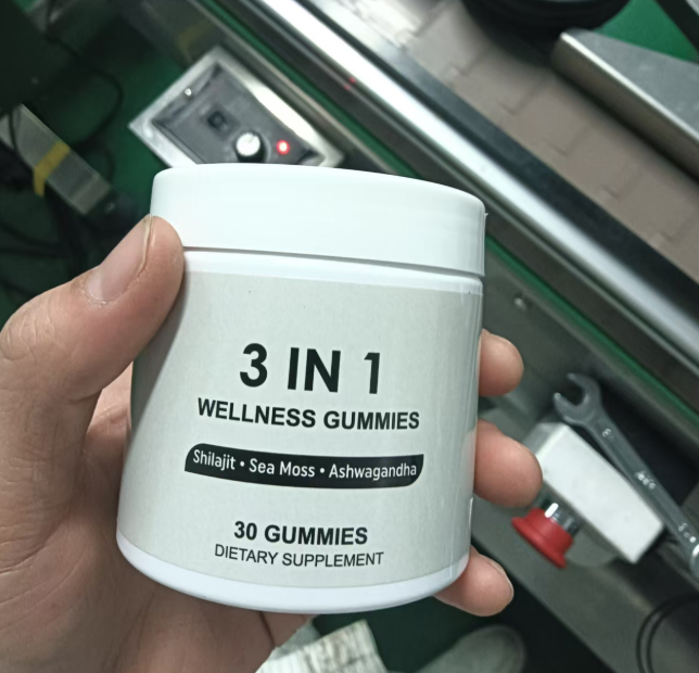 Hand holding 3 in 1 wellness gummies jar, label shows dietary supplement
