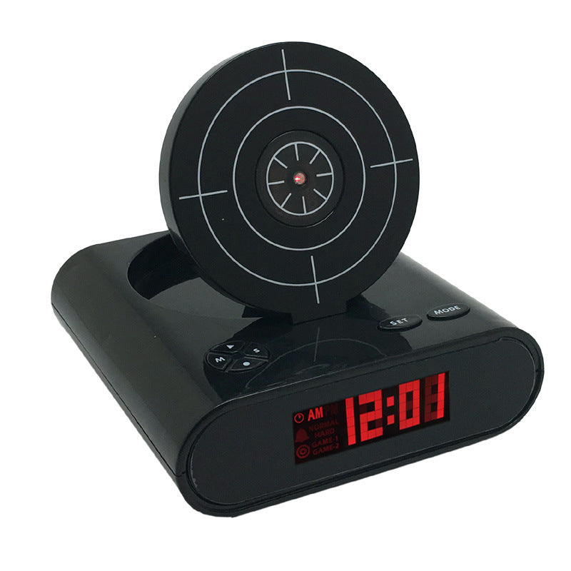 Black target alarm clock with circular crosshair dial, red LED time display 12:01 AM and buttons on top.