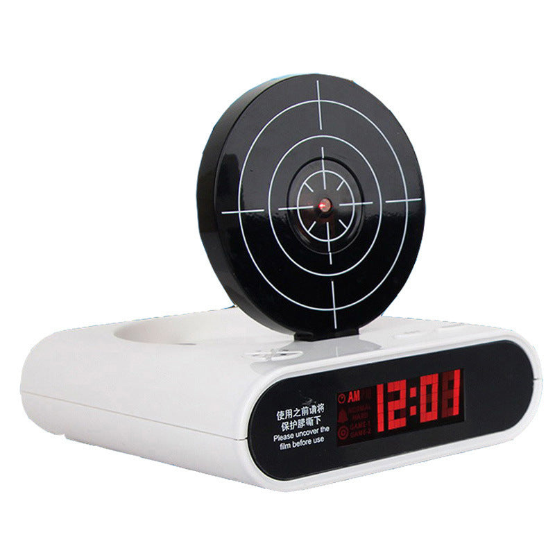 White target alarm clock with black circular aiming dial and red LED time display 12:01 AM.