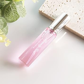 Pink perfume roller bottle with silver cap, tilted side view