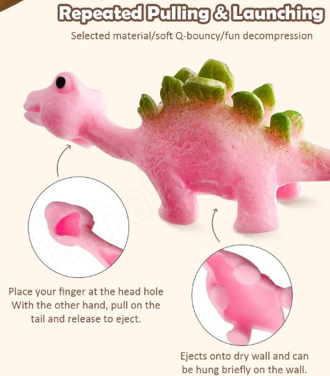 Pink dinosaur slingshot finger toy with spiky green head and body detail