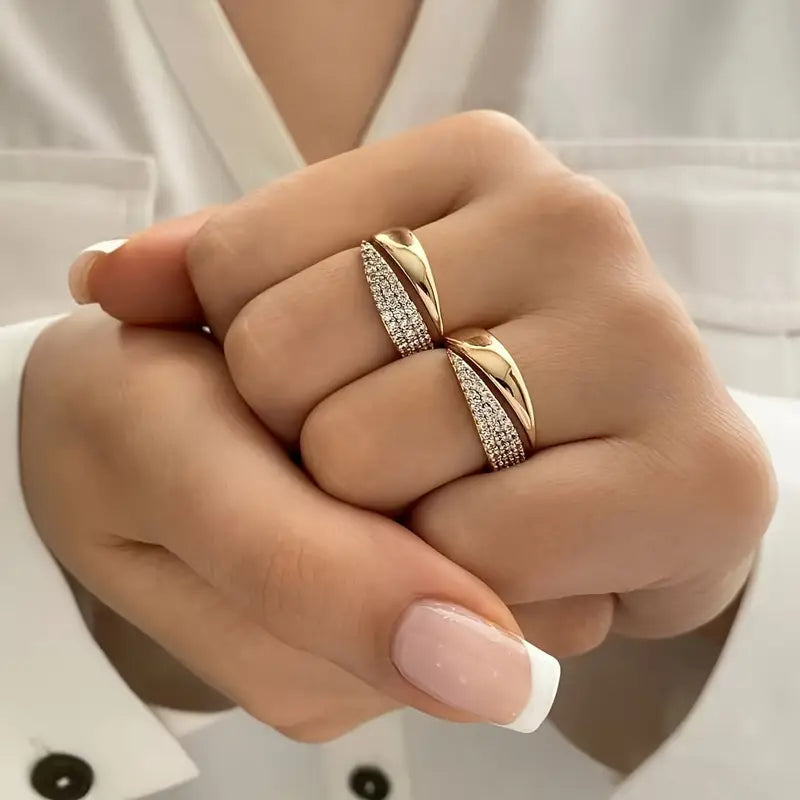 Gold-tone pavé band ring with sparkling stones, worn on two fingers
