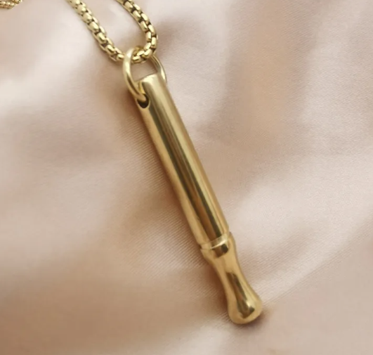 Breathing necklace pendant with gold-tone chain and gold capsule