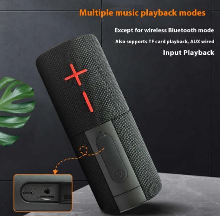 Black portable speaker showing bottom ports and textured grille with red accents