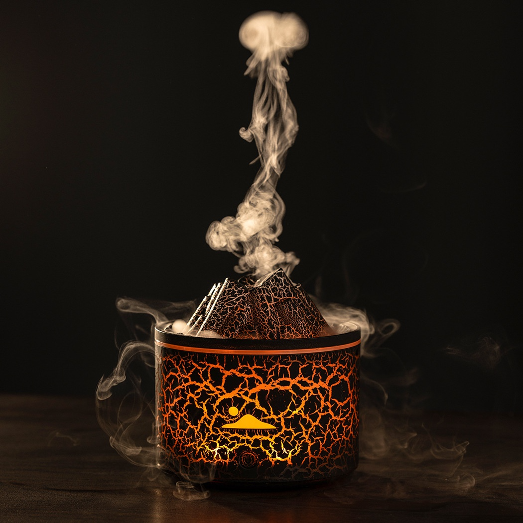 Aroma diffuser with lava-style crackled black-and-orange container and rising steam