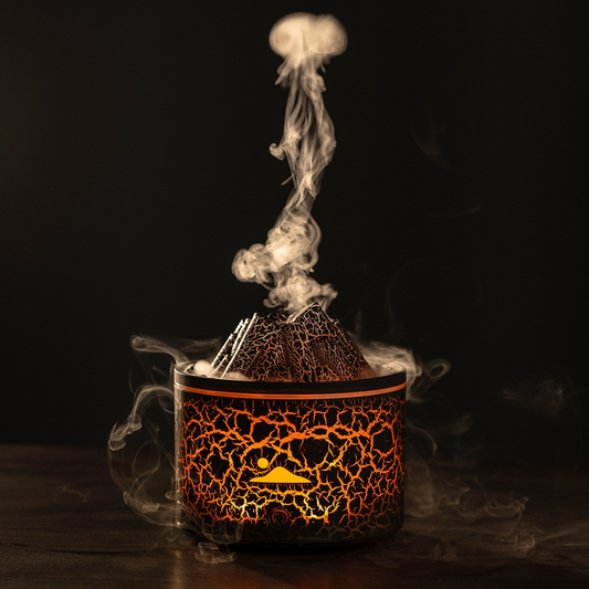 Aroma diffuser with lava-style crackled black-and-orange container and rising steam