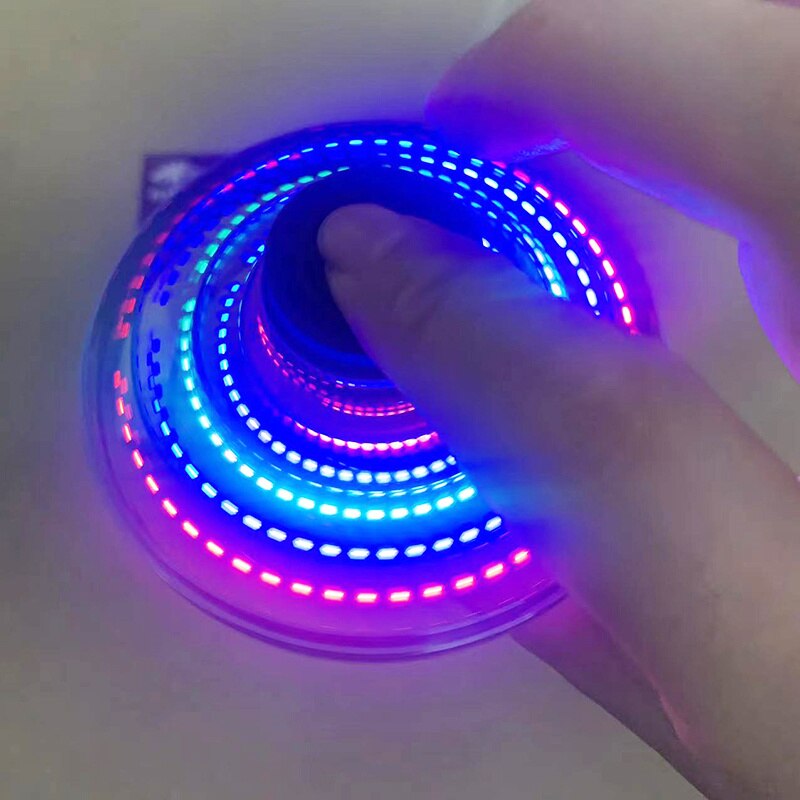 LED mini UFO spinner in hand, glowing blue and red ring lights