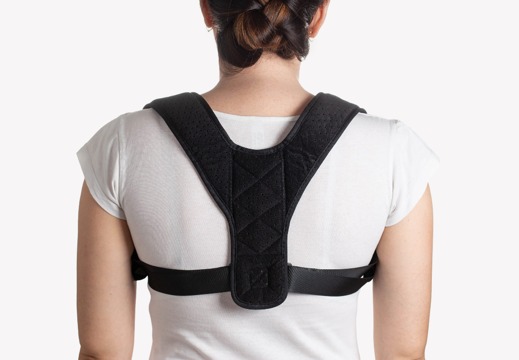 Black posture corrector back brace with padded back panel and adjustable straps