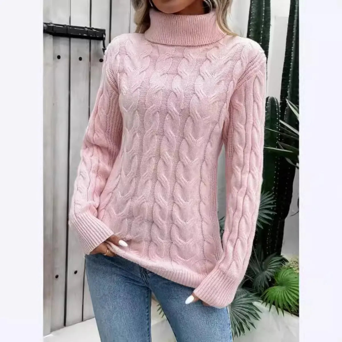 Light pink cable-knit turtleneck pullover with cable pattern and long sleeves