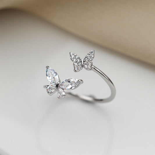 Sterling silver butterfly ring with three crystal-cut stones and open band