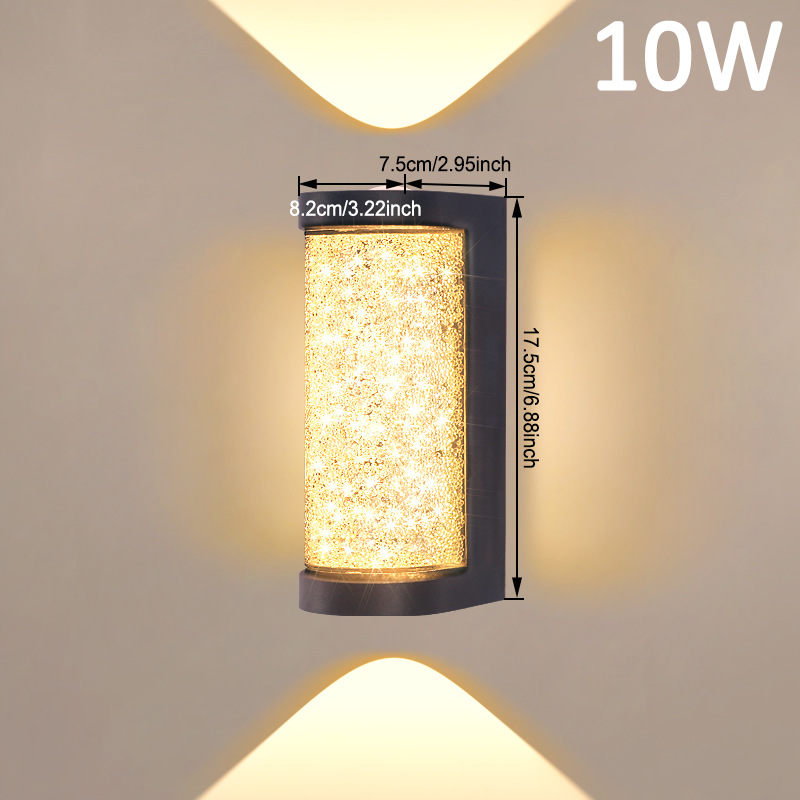 Square LED wall sconce with speckled amber glass cylinder and black frame, warm glow