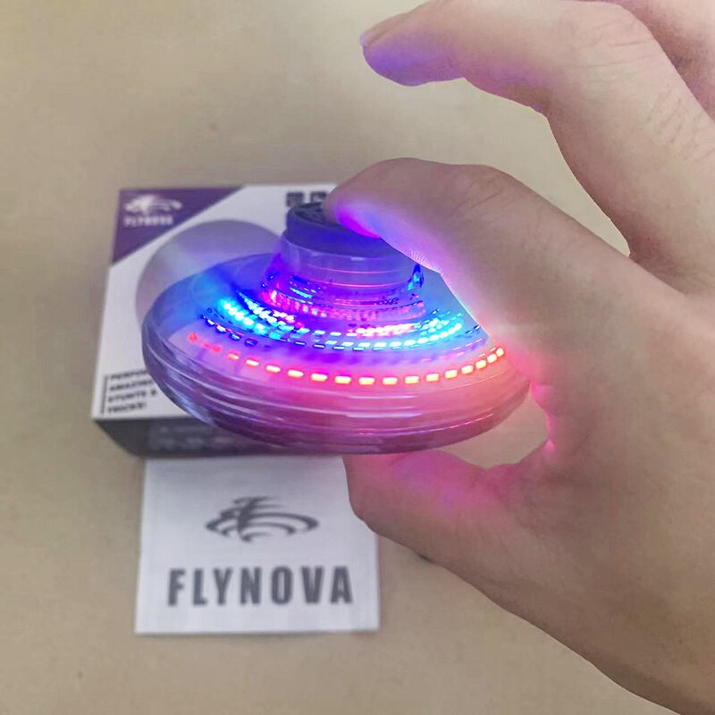 Mini UFO spinner in hand, bright multicolor LED ring lights