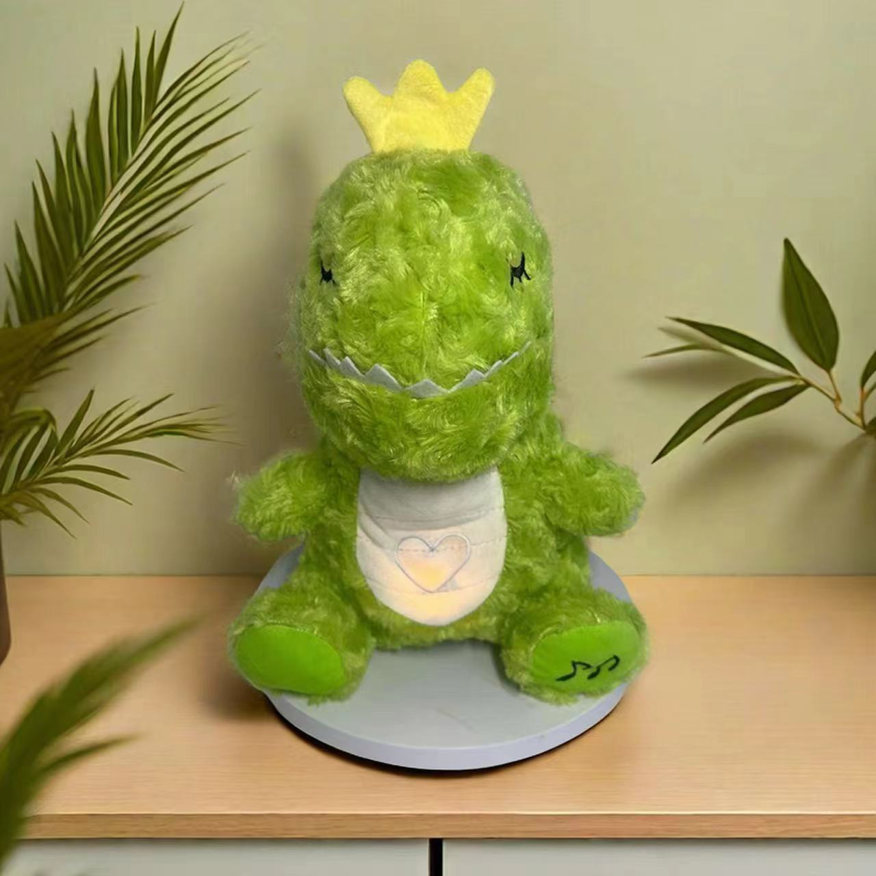 Green unicorn plush music toy with small crown and glowing heart panel
