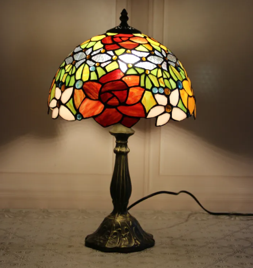 Stained glass bedside table lamp with multicolor floral shade and dark bronze base