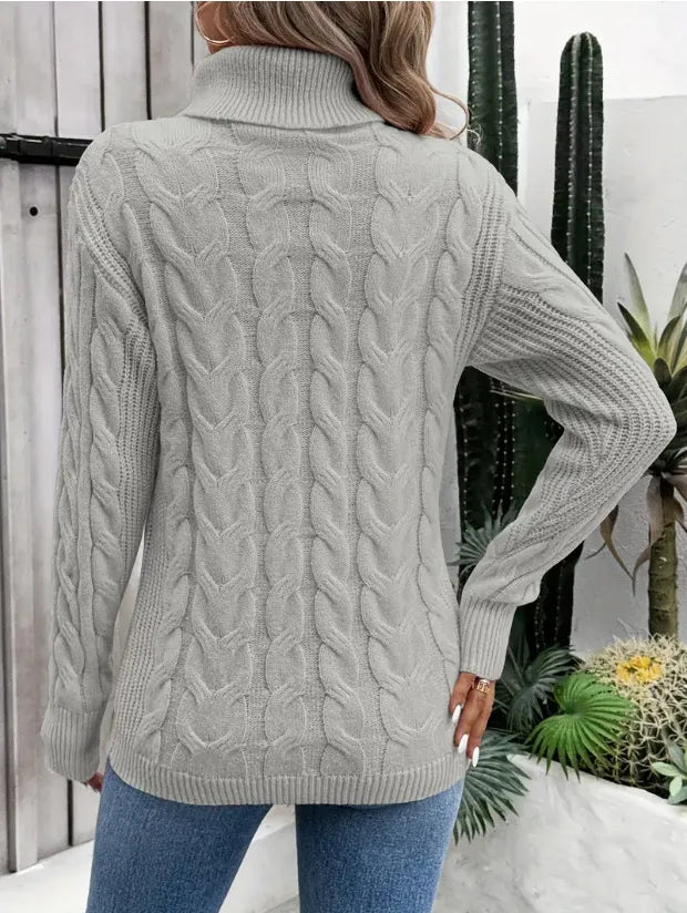 Light gray cable-knit turtleneck sweater shown from the back with long sleeves