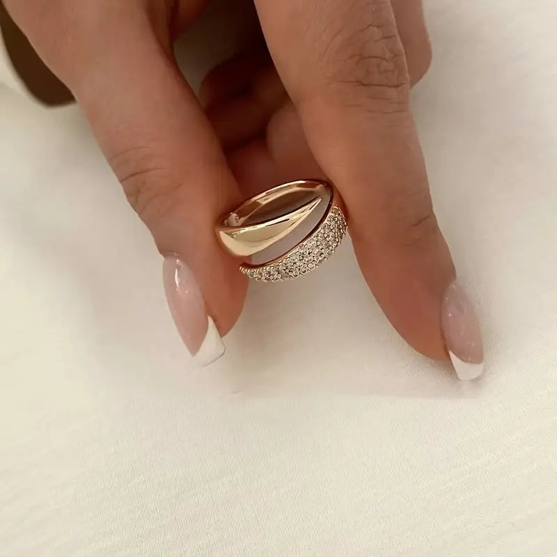 Gold-tone pavé band ring close-up with glittering pave stones and curved profile