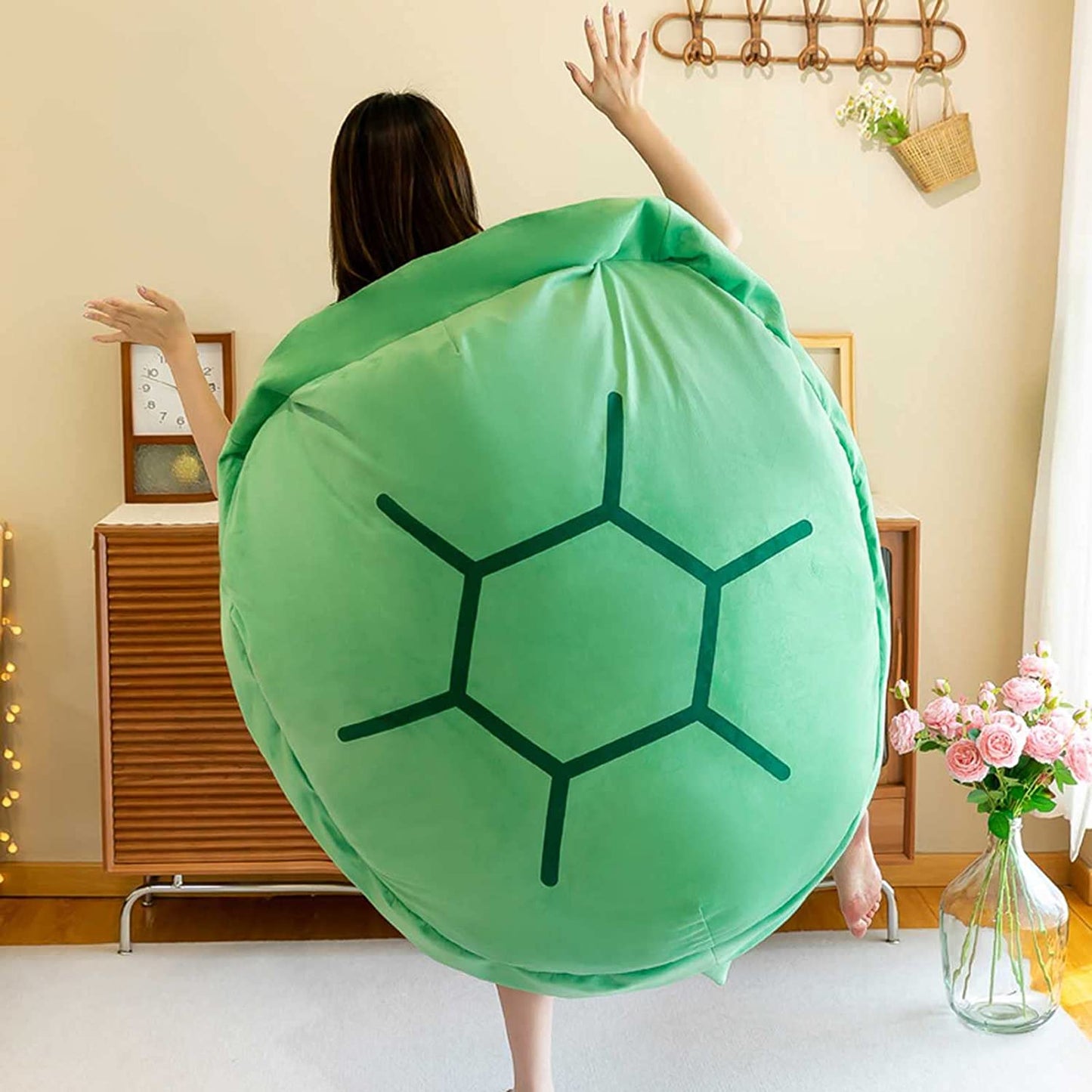 Green turtle shell wearable pillow worn on back, round shell with black line pattern