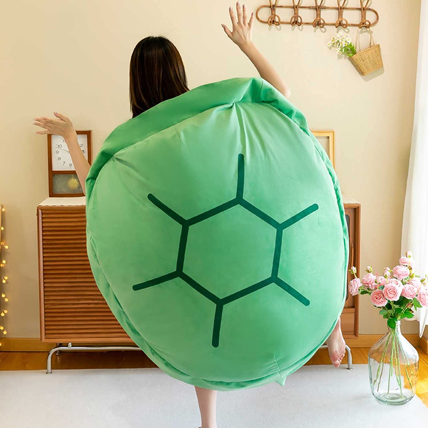 Green turtle shell wearable pillow worn on back, round shell with black line pattern