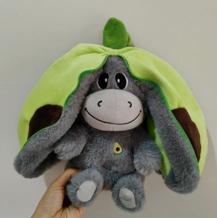 Plush breathing music doll, gray donkey with green hood and yellow chest emblem