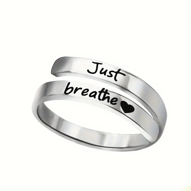 Silver spiral heart ring with "Just breathe" engraving and heart motif