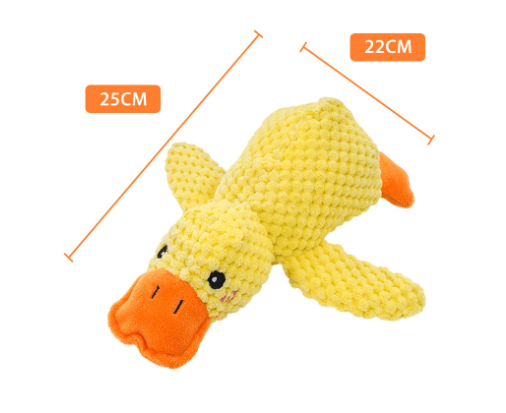 Yellow plush duck toy with orange beak and feet, side view on white