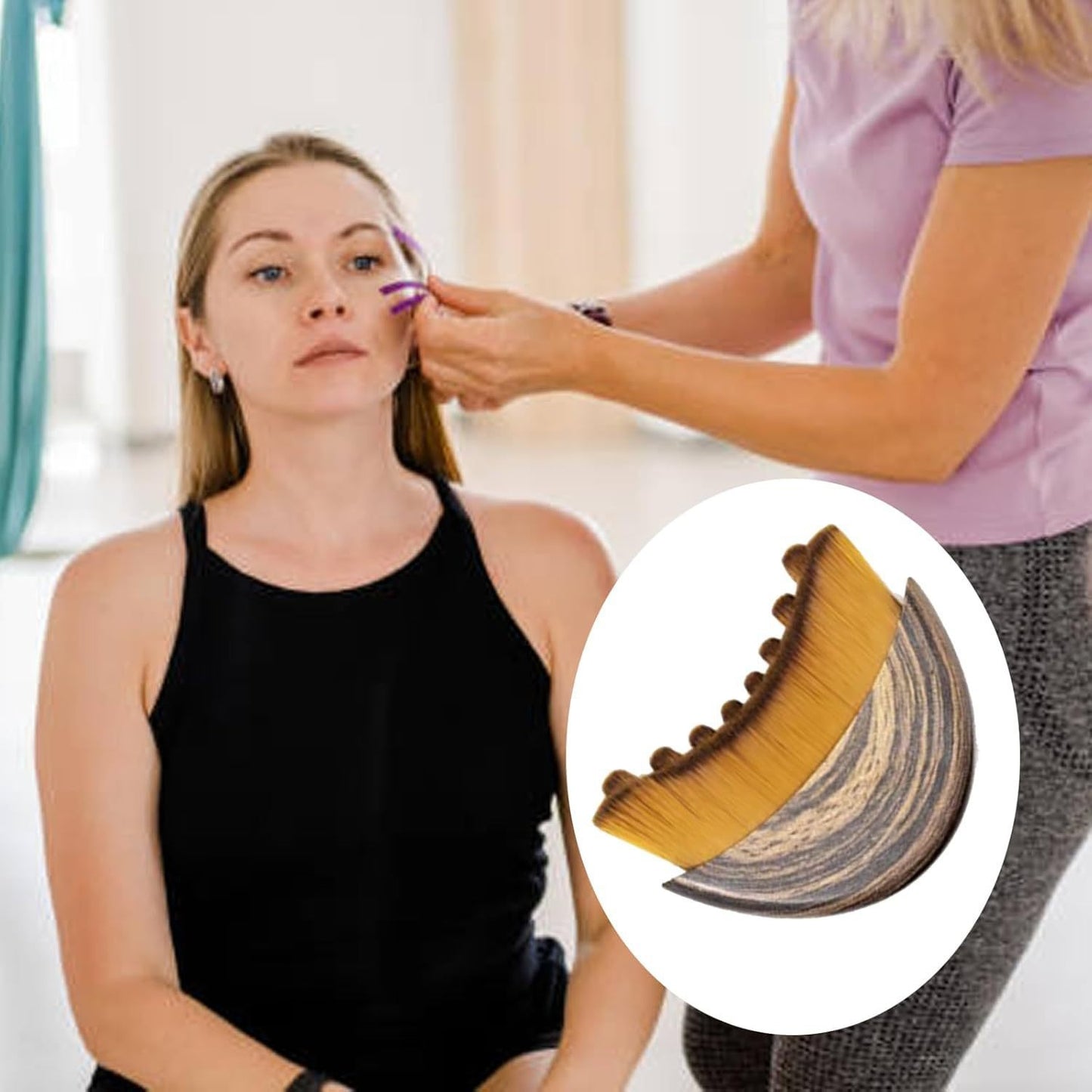 Facial lymphatic drainage massage brush with curved wooden bristles and white backing