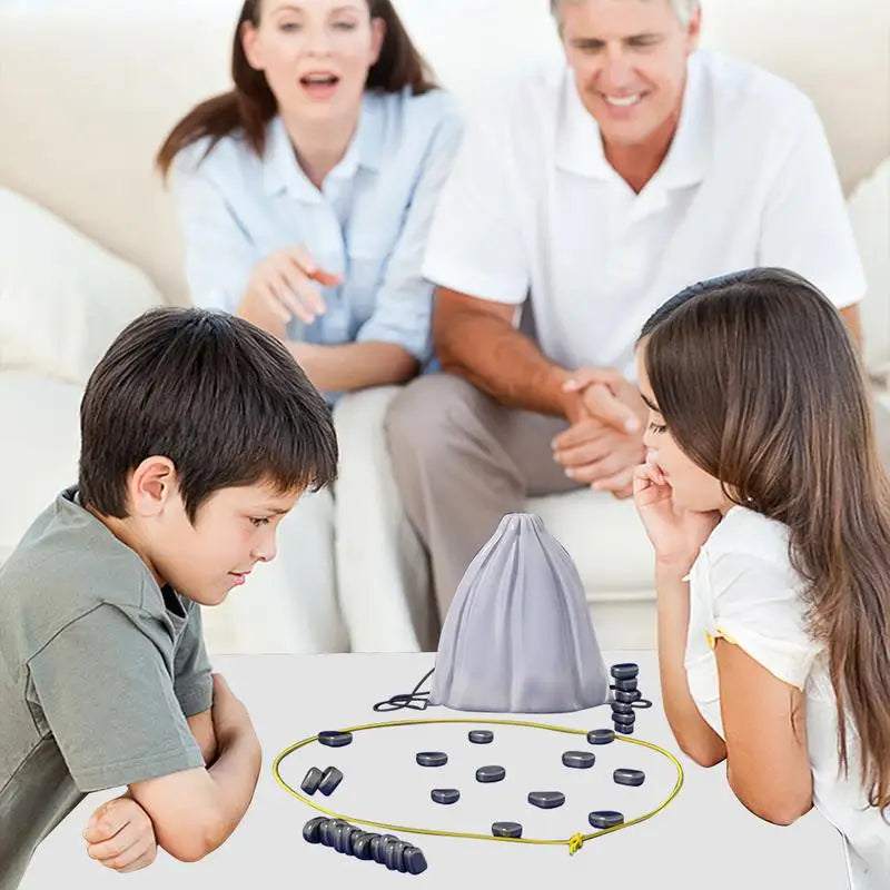 Magnetic chess travel set on table with blue pieces, purple mat, and gray bag