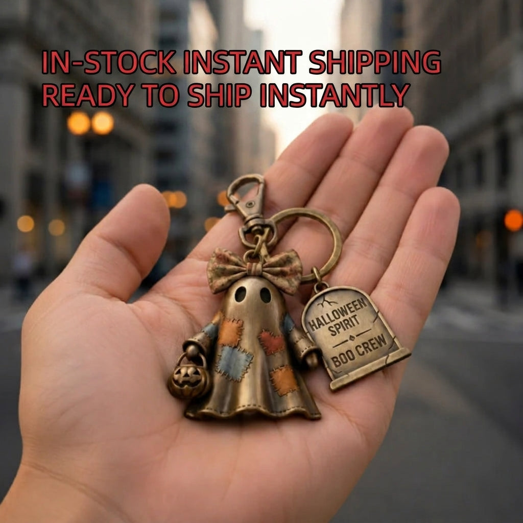Halloween ghost keychain charm in open palm with bronze ring and Boo Crew tag