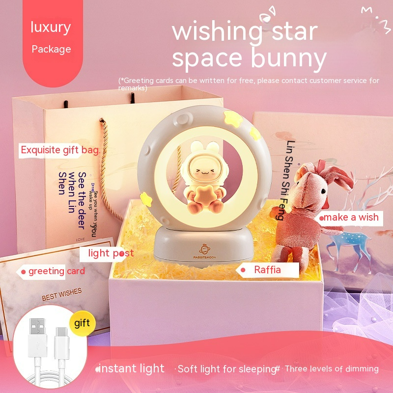 Pink bedside night light with glowing ring and bunny figure in center
