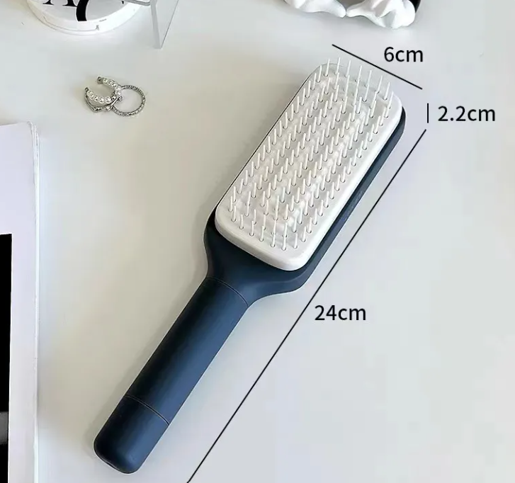 Self-cleaning hair brush with white bristle pad on dark blue handle, 24 cm