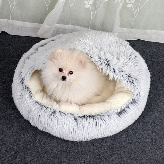 Plush pet bed with tunnel opening, white-gray fur, small dog resting in bed.