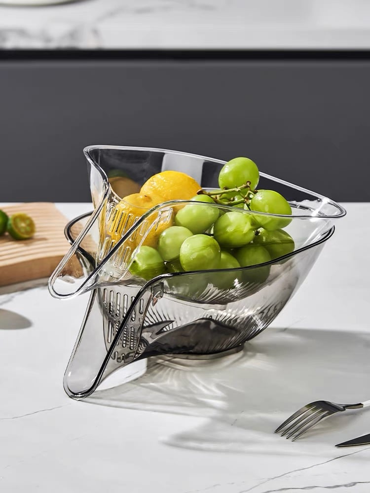 Transparent PCTG drain basket colander with side spout handles, holding fresh produce