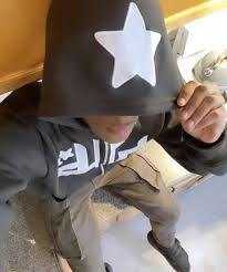 Dark gray zip-up hoodie hood with white star patch and front zipper detail