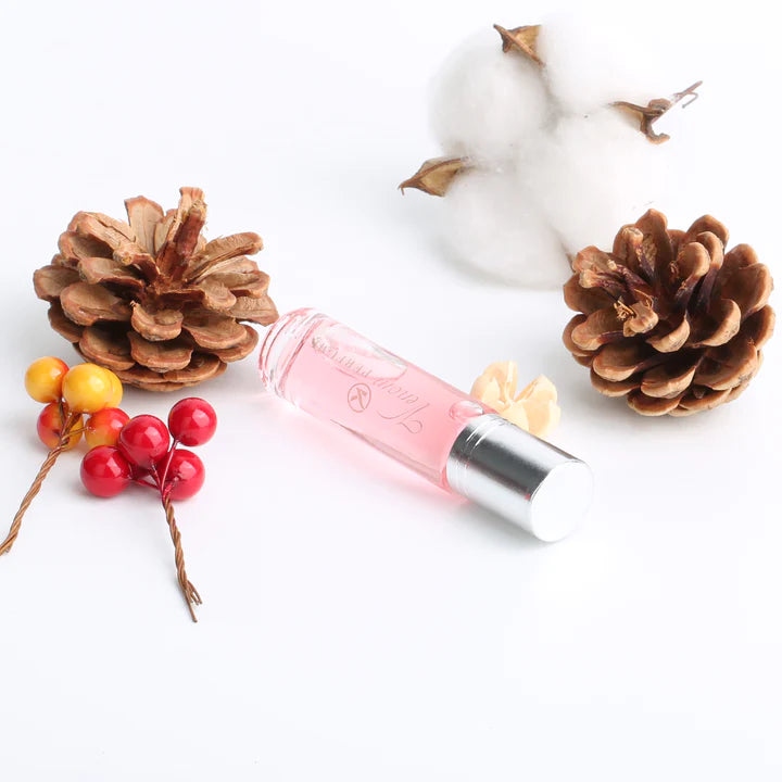 Pink perfume roller bottle with silver cap and roller tip