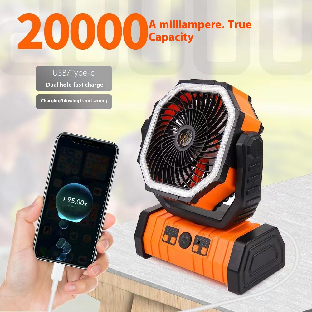 Orange portable camping fan with power bank, smartphone charging beside fan