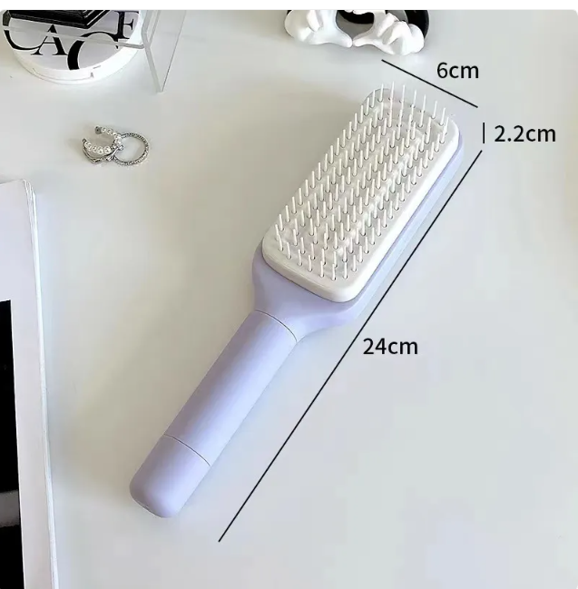 Self-cleaning hair brush with white bristle pad on light purple handle