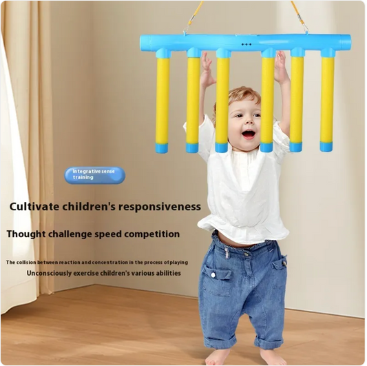 Kids sensory reaction trainer toy with blue top and yellow hanging rods, child playing