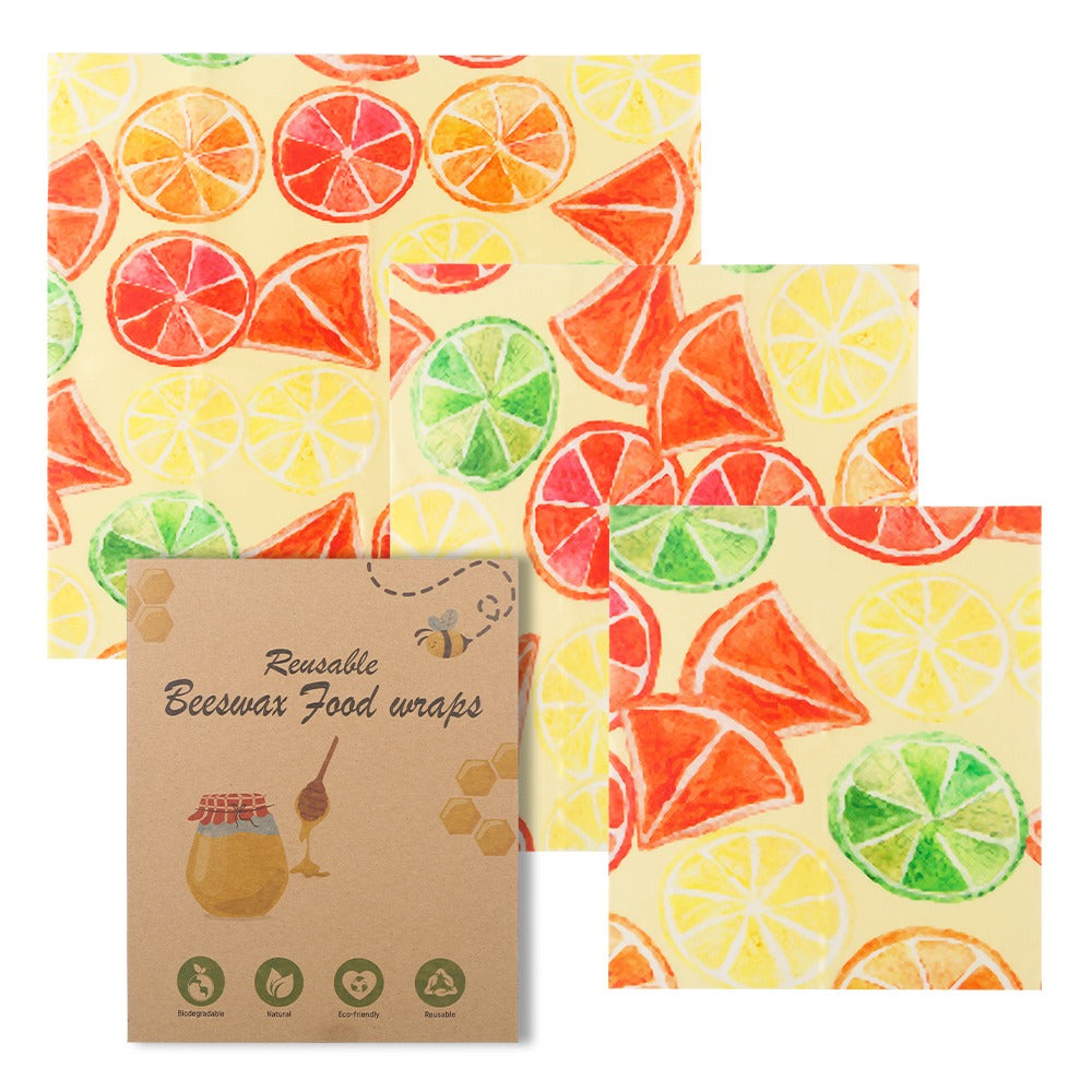 Reusable beeswax food wraps with colorful citrus slice pattern, shown in a three-pack