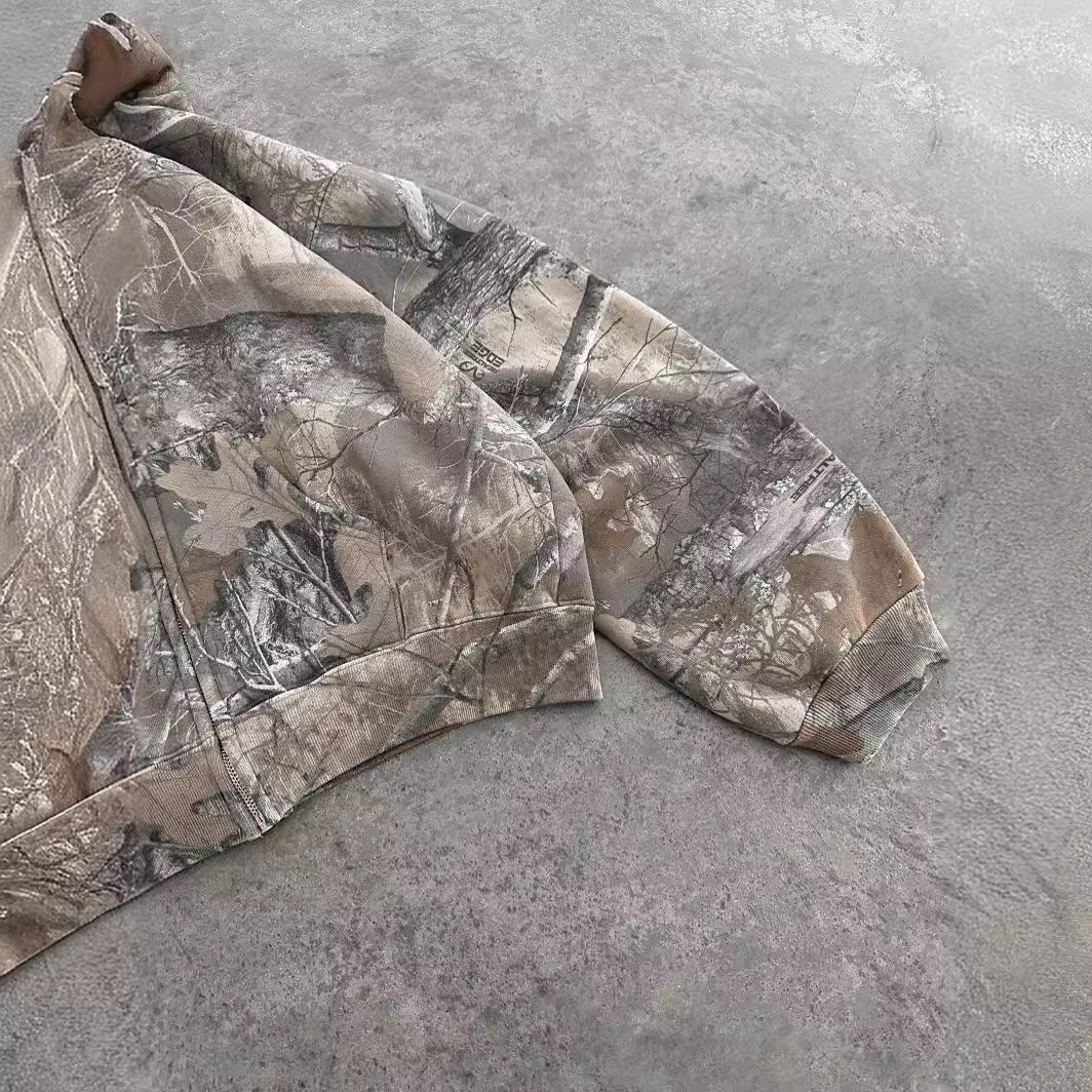 Camouflage hoodie sleeve and cuff, gray tan tree-branch print on fabric