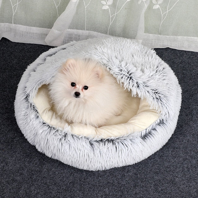White and gray plush pet bed with tunnel entrance, small dog resting inside