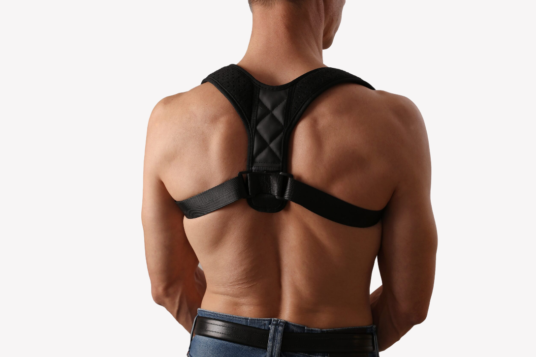 Black posture corrector back brace with cross-back straps and center buckle