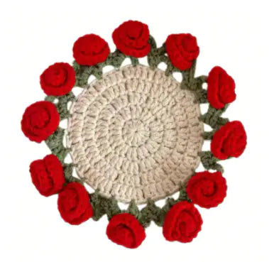 Crocheted coaster with cream center and red rose-like crochet flower border