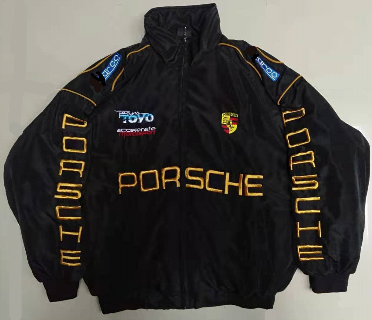 Men's black bomber jacket with Porsche text, TOYO accelerate badge, crest, and yellow piping