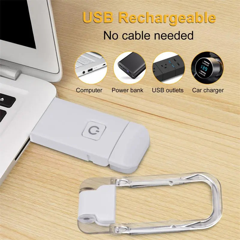 White USB rechargeable clip-on LED book light with clear clamp on a desk