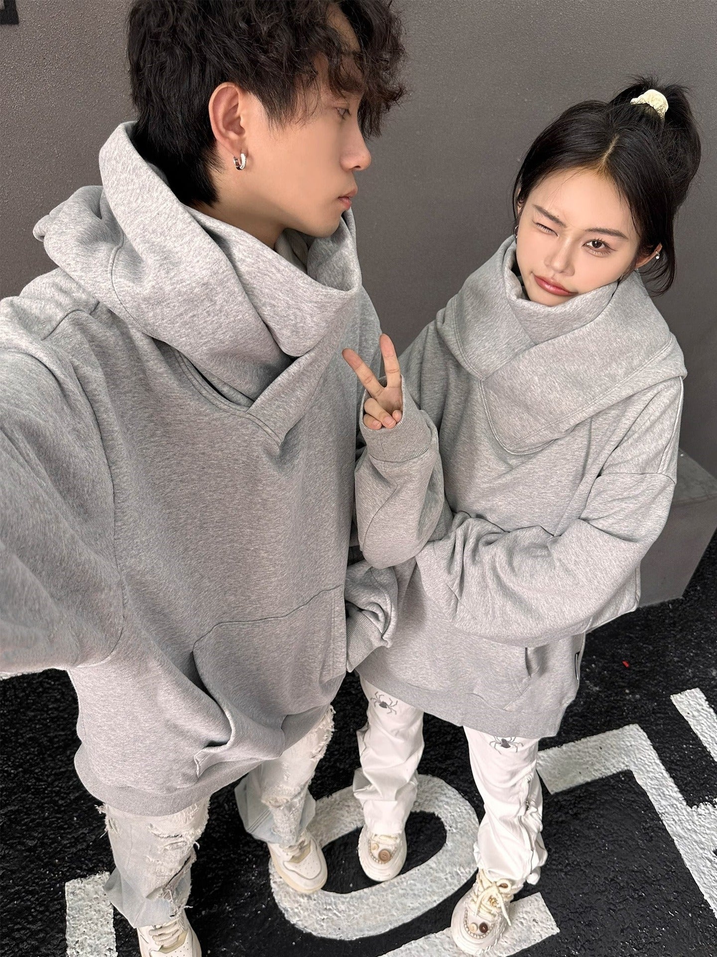 Two gray high-collar hoodies with oversized hoods and front pouch pockets
