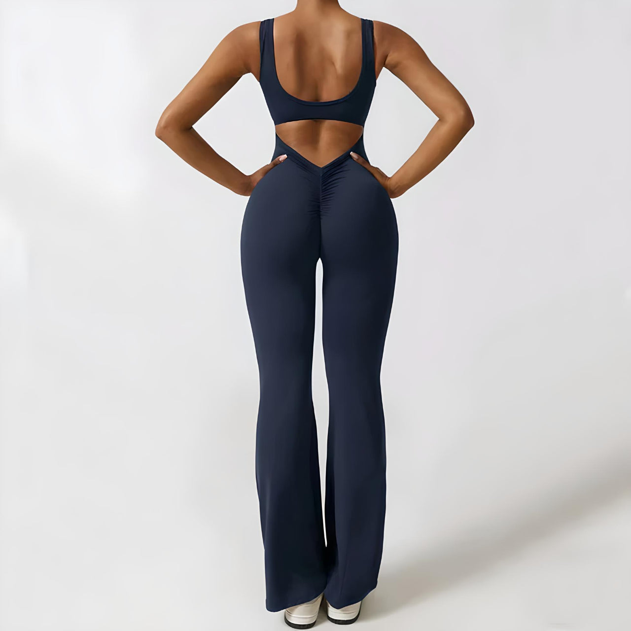 Blue sleeveless flared jumpsuit with waist cutout and wide bell-bottom legs