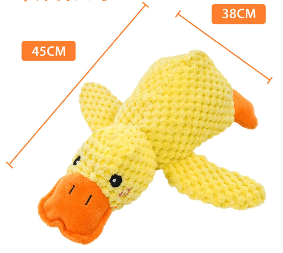 Yellow plush duck toy with orange beak and feet, angled side view on white