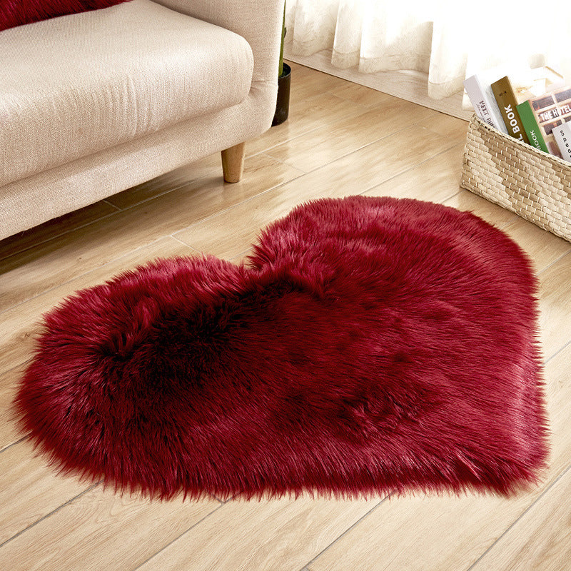 Red long-pile heart rug with soft shag texture and darker center area.