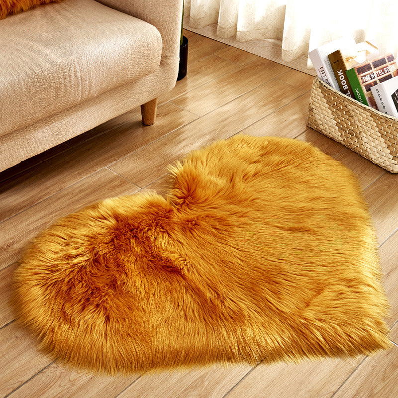 Plush heart-shaped rug with long golden faux-fur pile, textured plush surface